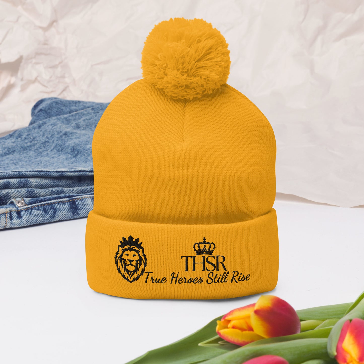 THSR Gold Pom-Pom Beanie with Black Embroidered THSR KING Lion & Crowned THSR True Heroes Still Rise Logo – Warm, Stylish Winter Hat