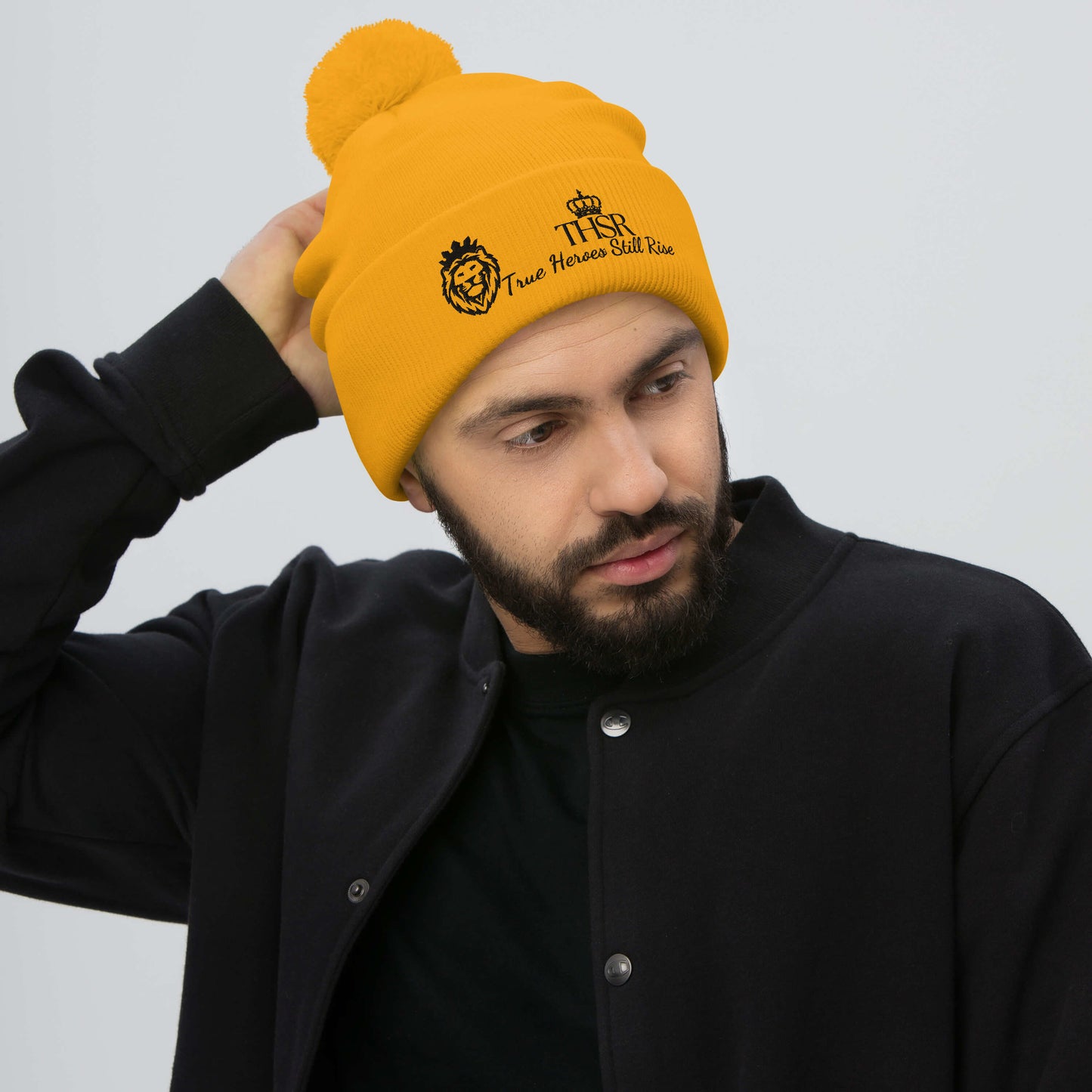 THSR Gold Pom-Pom Beanie with Black Embroidered THSR KING Lion & Crowned THSR True Heroes Still Rise Logo – Warm, Stylish Winter Hat